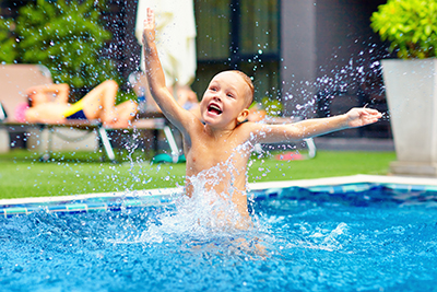 Boy Jumping in Pool